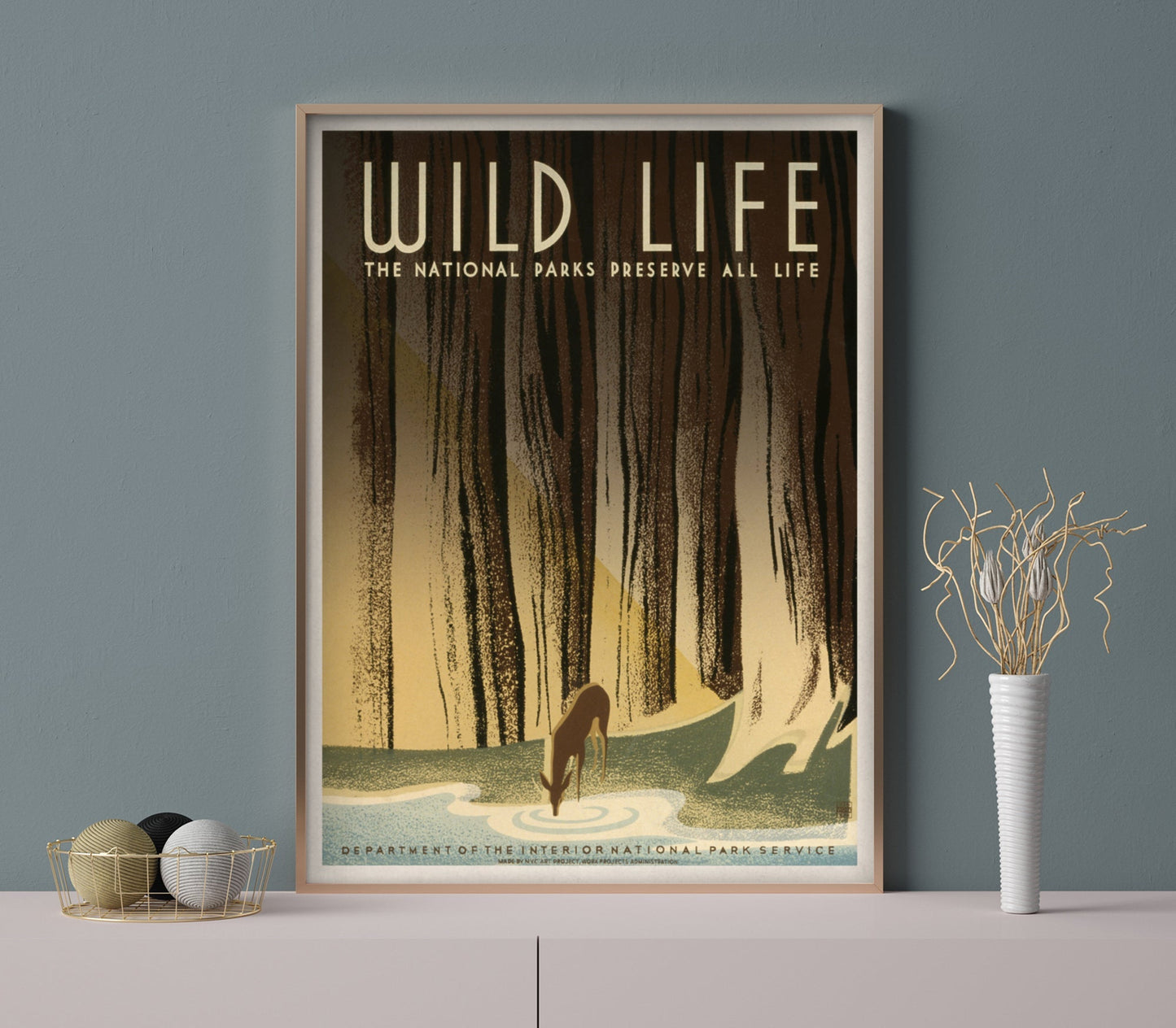 A framed vintage travel poster featuring a forest and a wild animal, with the text 'Wild Life - The National Parks Preserve All Life'.